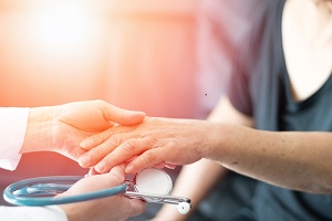 This is a picture of a doctor holding a patients hand