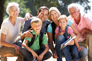 A photo of a family squatted down posing for a photo