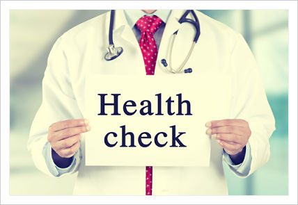 A medical professional holding a sign reading health check
