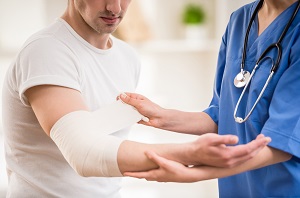 This is a picture of a nurse rapping up a patients arm.