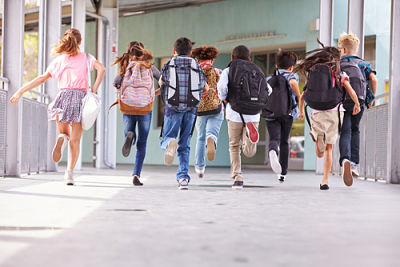 Picture of kids running into a school.