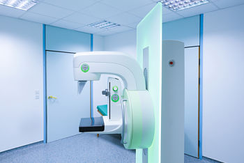 Picture of 3D mammogram machine in an exam room.